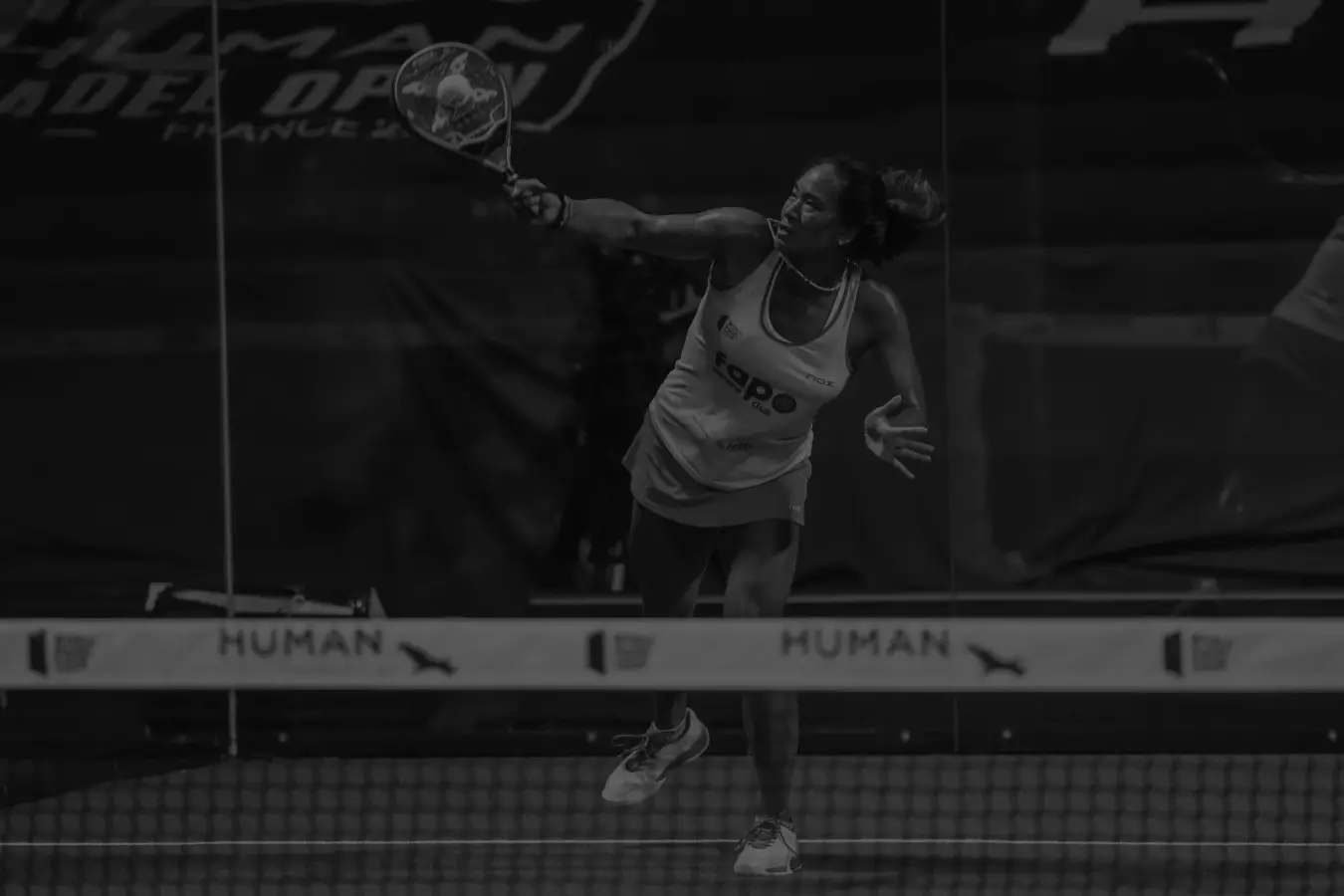 Padel player executing a bandeja with precision, maintaining control during a match at the Human Padel Open.