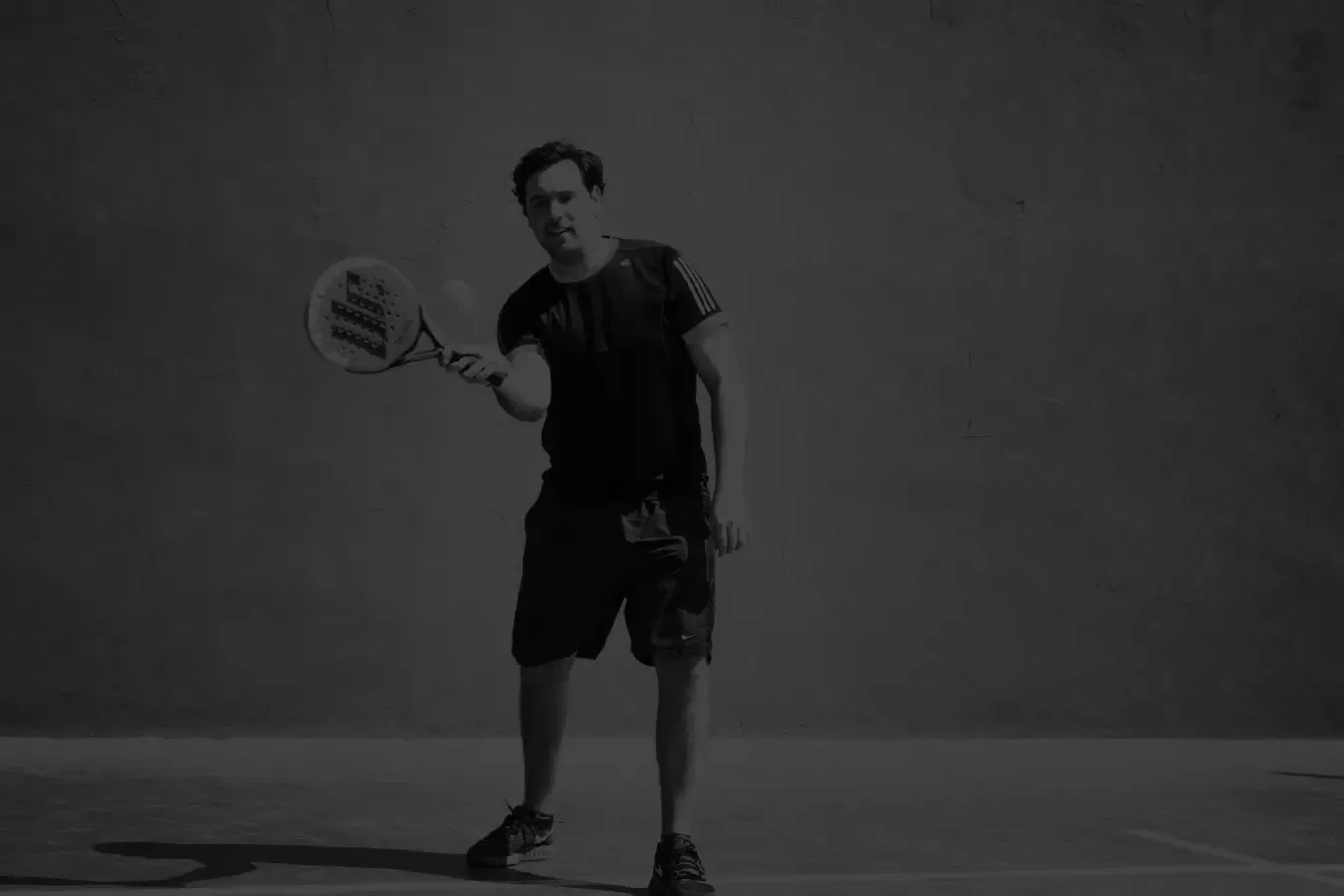 man hitting the padel ball